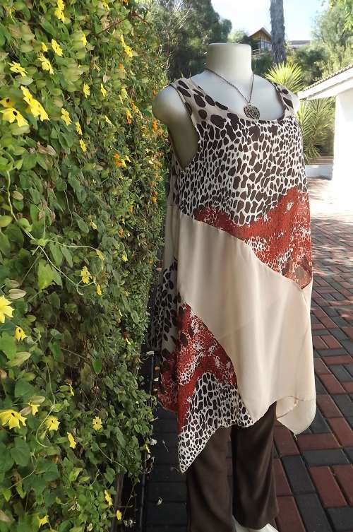 Beautiful long top with high/low seam.Size 34/10 by Pierre Mailhe Paris.In animal print and beige