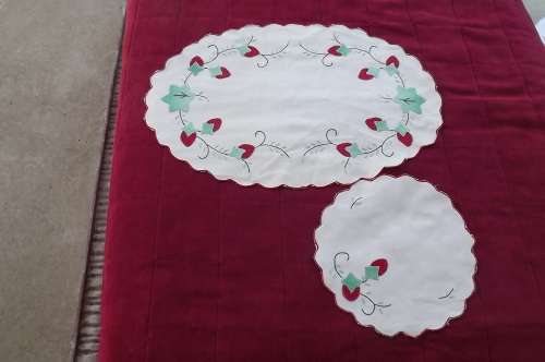 Oval vintage cotton doilies. One large one smaller. red embroidered berries with scoloped edging.