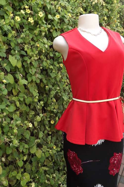 Chic bright peplum top with v neck in heavy polyester wash + wear fabric.Size 36/12.Beautiful fit