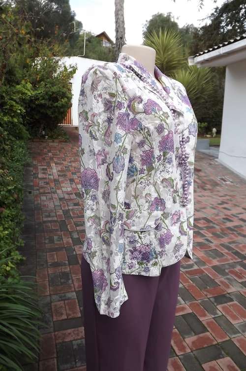 Amazing white acrylic lace jacket with a medley of purple/pink flowers.By Monzl size 36/12
