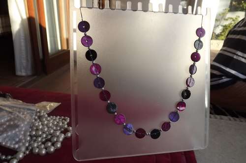 Fashion necklace in circles and string.In different purples.Length 79cm.As new
