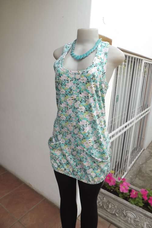Pretty turquoise and pink floral top with elasticated seam.Size 32/8.Two large pockets on front