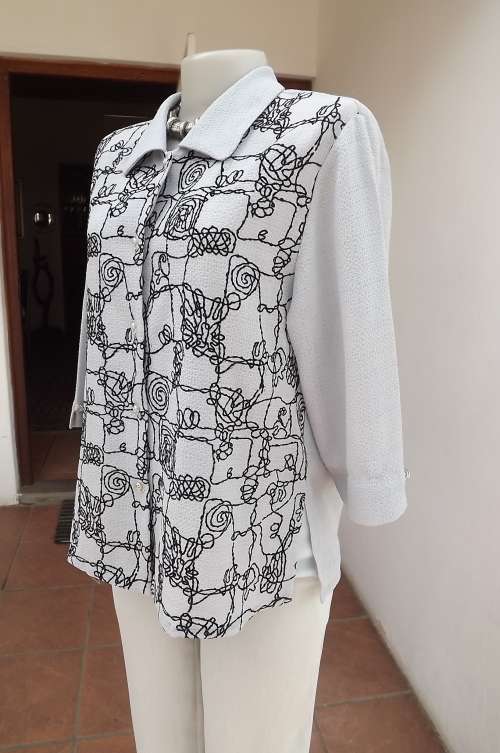 Wonderful silver grey top/short sleeve jacket size 36/12.Black graphic embroidery on front.