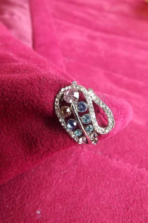Dainty silver toned ring with lots of colourful stones.Pretty design.Rhodium plated .Size 7. New