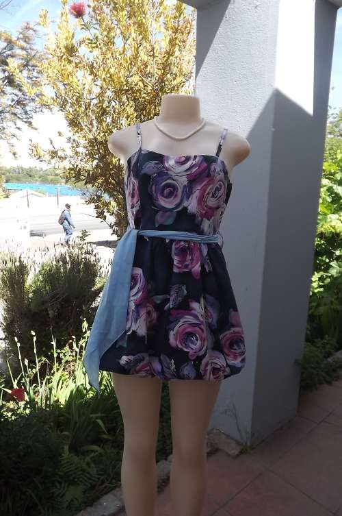 Navy balloon style mini dress with bold pink/purple flower design.Size 32/8.Fully lined.