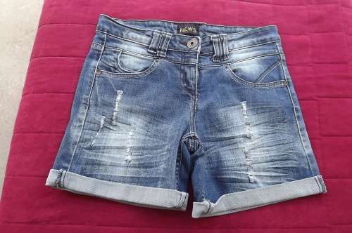 Chic and sexy denim shorts by NEWS.In distressed look.Leg turnovers.Size 30/6.As new