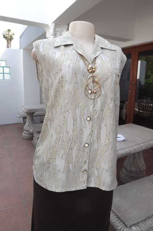 Fabulous beige sleeveless top in marbled pattern.Size 36/12.Button down with pretty buttons