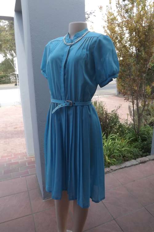 Beautiful turquoise vintage dress with permanent pleated skirt.Size 37/13.Elasticated middle.