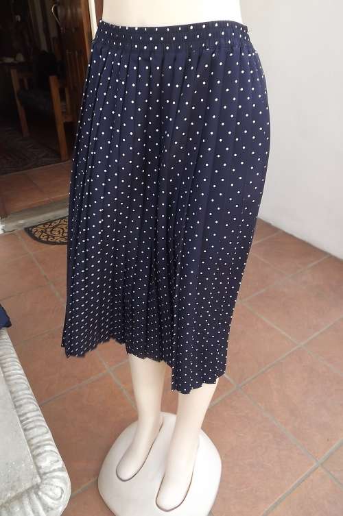 Smart navy with white polka dot wash + wear polyester skirt.Permanent knife pleats size 48/24