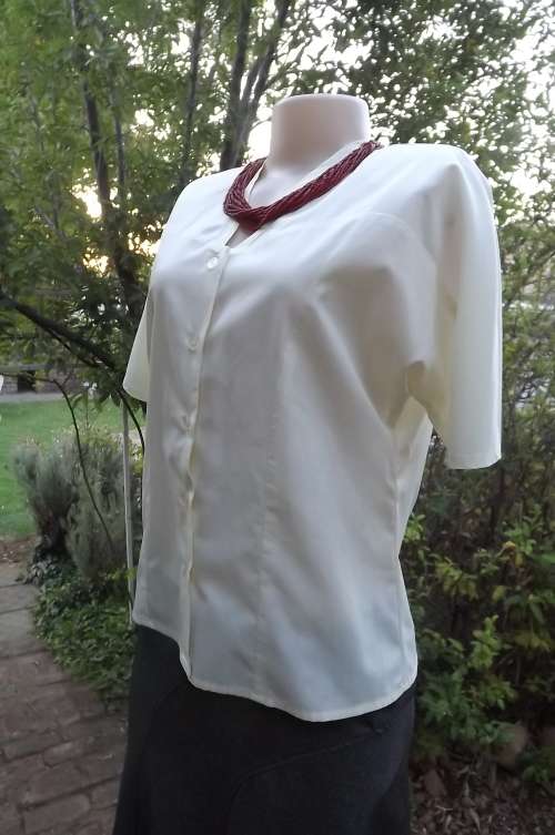 Cool vanilla colour polycotton button down top with v neckline.Size 36..Short dolman sleeves.
