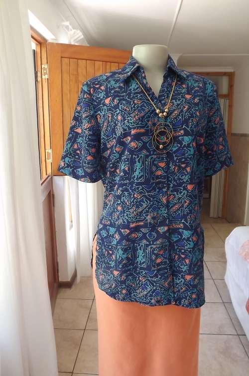 Pretty short sleeve 100% polyester blouse in different blues with coral touches by NISSI size 36/12