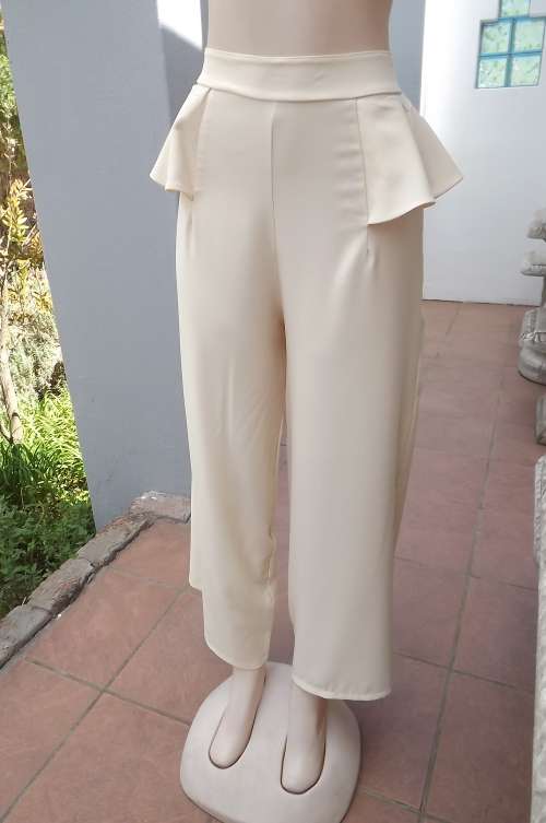 Sassy cream high waisted pants in size 36/12 with peplum waist.Made by Boutique