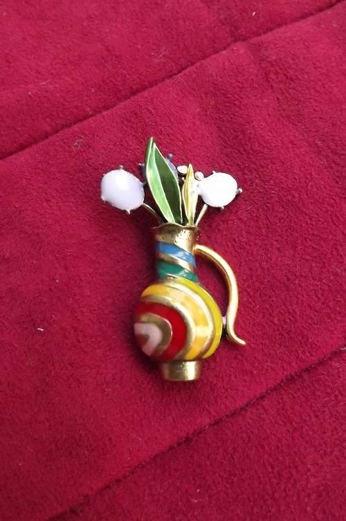 Colourful brass toned brooch.Vase with flowers in purples and green enameled.Beautiful.