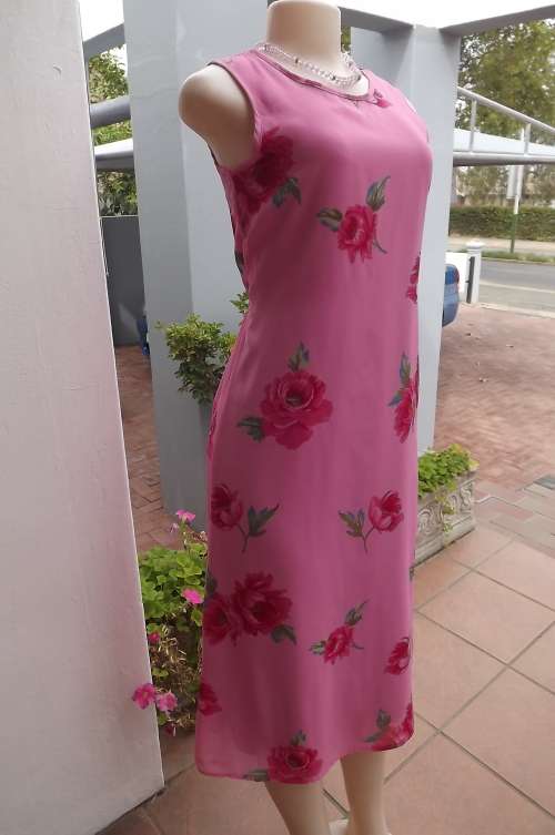 Beautiful fully lined size 30/6 pink sheath dress with dark pink roses.In sheer polyester.As new.