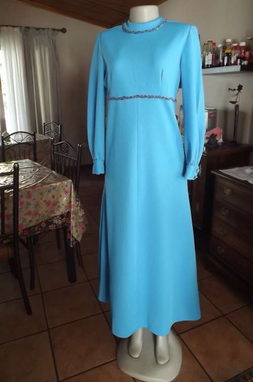 Sky blue vintage long crimplene dress with high neckline.Size 36/12.Long cuffed sleeves.