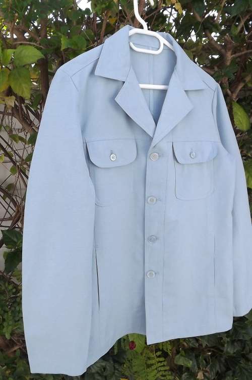 Handsome light blue Safari style jacket with long sleeves in heavy polyester.Size S.Chest 98cm