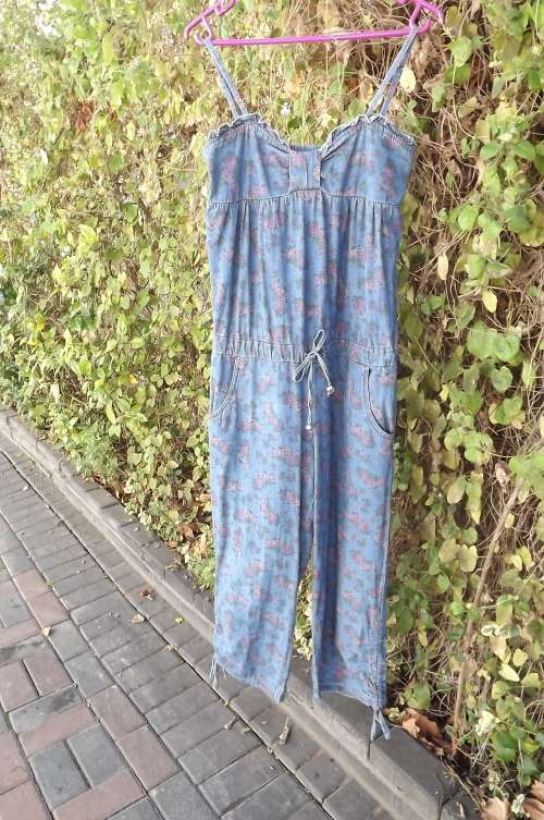 Floral denim jumpsuit by BEGUM in size 30/6 with pink rose pattern.Drawstring in middle.
