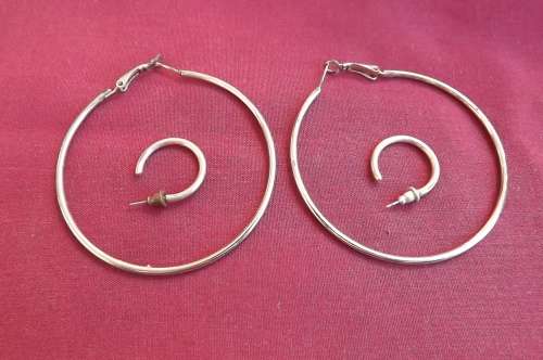 Two pairs similar piercing earring only in different sizes.Large ring earrings 6.5cm diameter