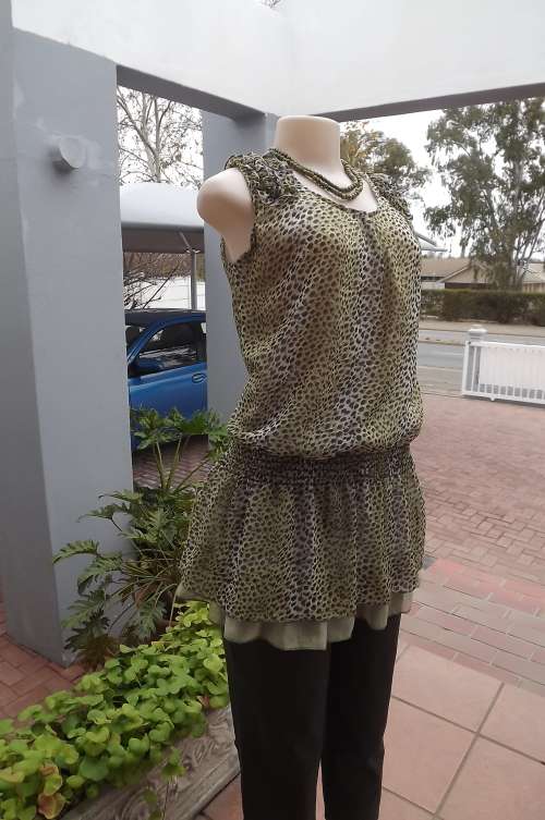 Animal print long top on mint green background.Blouson style elsaticated in middle.