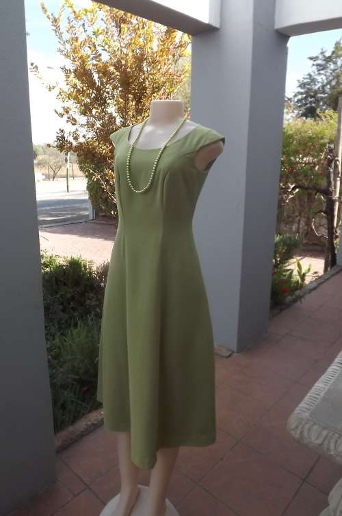 Princess style dress with a-line bottom in apple green.Fully lined.Size 32/8.Good condition