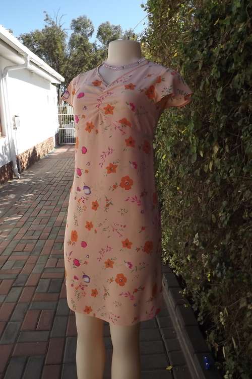 Soft apricot colour shift dress with empire waistline.Gathering in middle of neckline.Size 30/6