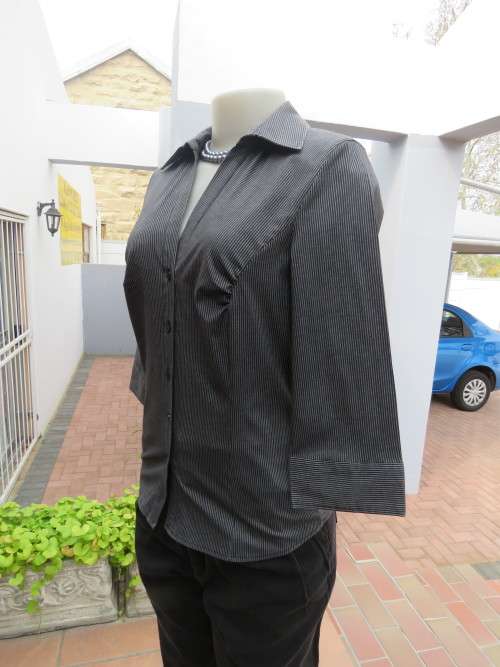 Chic tailored elbow length blouse in black and grey stripes.Size 32/8 by INSYNC.New condition