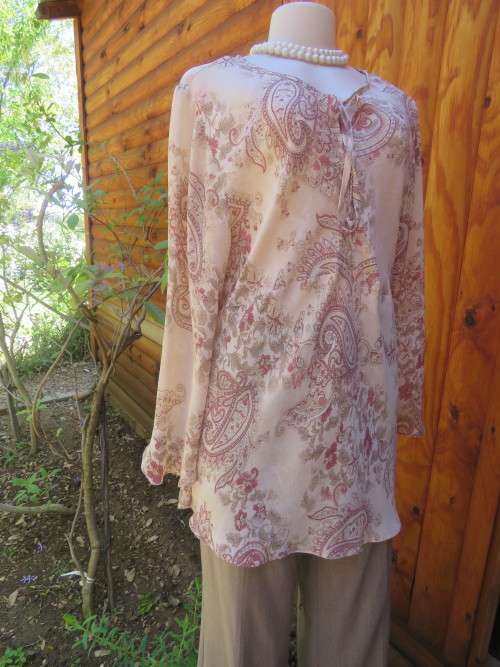 Pretty beige 100% polyester top with pink paisley patterns.Slit on neckline with tiestring.