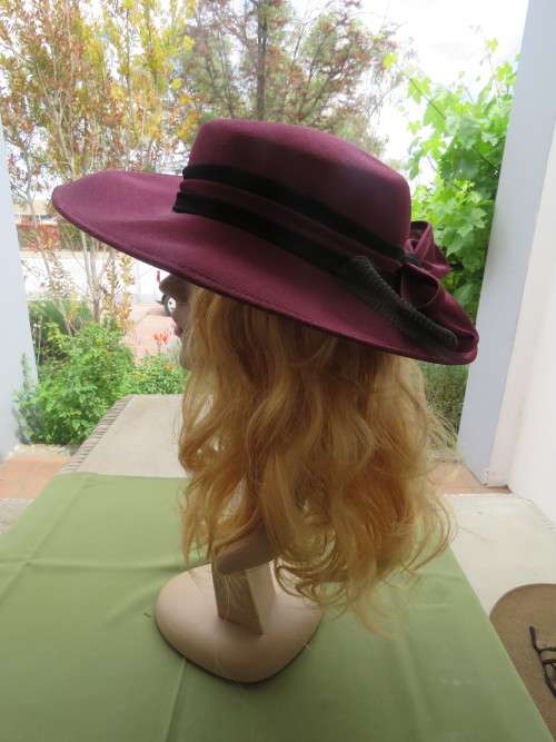Mulberry colour satin hat with medium brim.Black and mulberry band with double bow at back