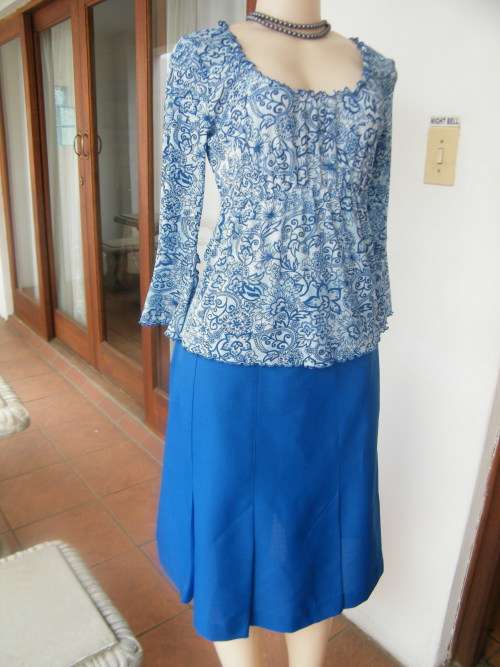 Paisley patterned blue on pale blue top in 100% stretch polyester.size 36/12 by NEWS.