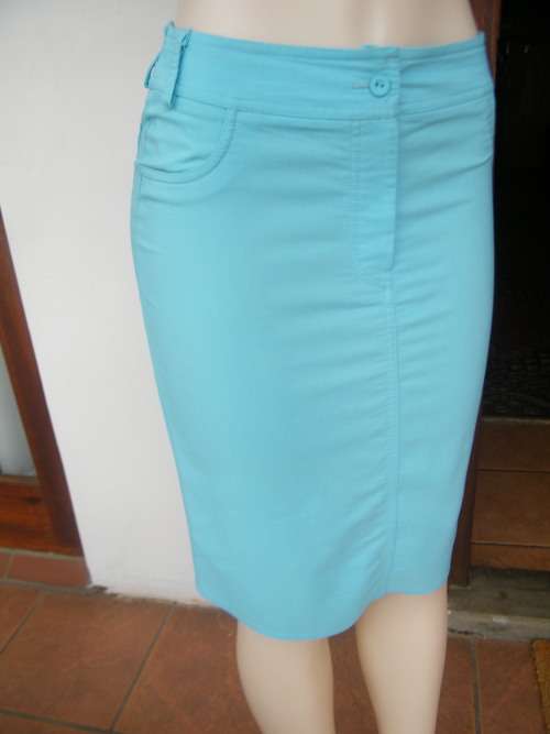 Skyblue 100% polyester knee length skirt in pencil style.size 34/10 by SMILEYS.Pockets at back
