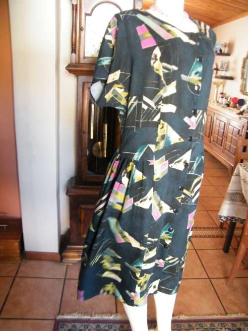 Black FASHIONETTE dress with geometric pink/green designs.Size 42/18.Button down front