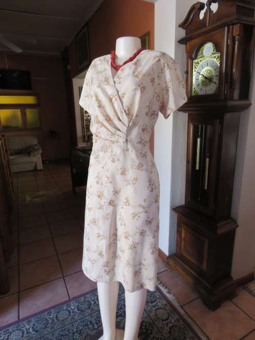 Beige floral rayon dress made by owner.Cross over front with pleats.Size 44/20.Light as a feather