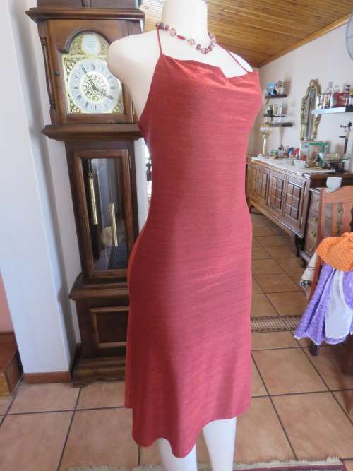 Sexy brickred polyester/nylon blend. Halter neck.Size 32/8 With cowl neckline. As new