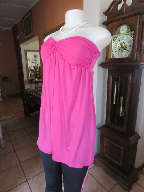 Sexy hot pink strapless lycra top by INSYNC FORMAL.Cross over bust.Size 32/34