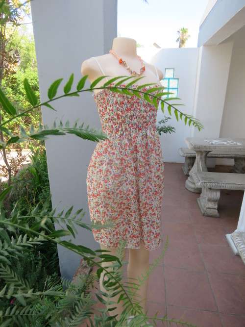 White floral mini dress with pink and blue flowers. Elasticated top with adjustable straps.Size 32/8