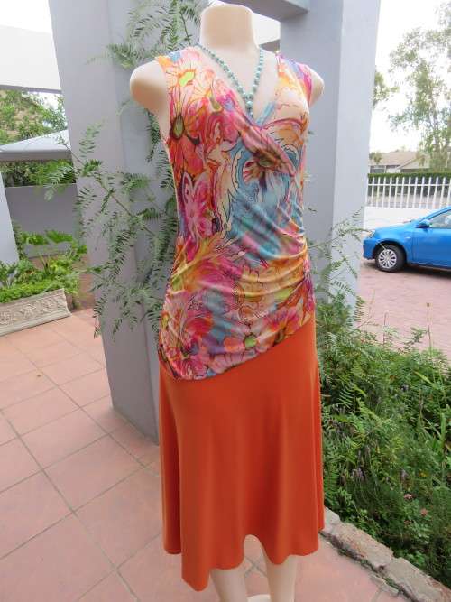 Try a burst of bright colours in this timeless styled dress by DREW in size 34/10.Cross over top.