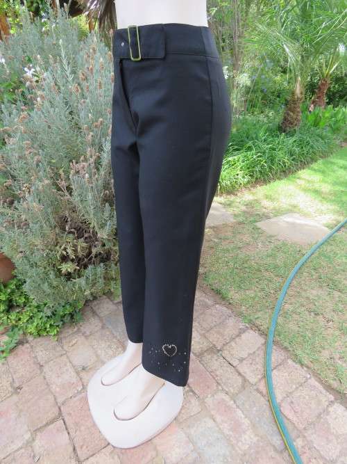 Smart black pants with straight legs.Size 36/12 by INSYNC.In firm polyester fabric.No pockets.