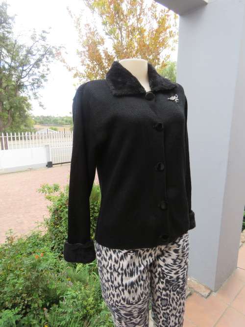 Top of the line black acrylic knit long sleeve cardigan.Button down front.Size 35/11.As new