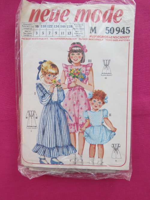 'NEUE MODE' sewing pattern 50945 for girls dress in sizes 3,5,7,9,11 and 13.