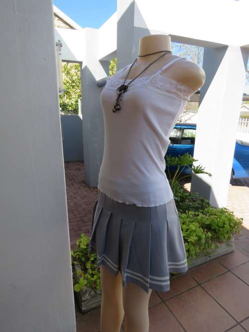 Sassy grey skort  knife pleated mini in heavy stretch polyester.Size 34/10.Shop sample-never worn.