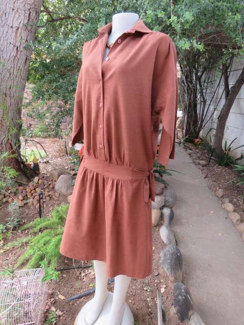 Mottled golden brown dress in size 35/11.In poly cotton fabric.Dropped waist.Good condition.