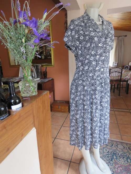 Black/white mottled viscose dress with white daisies.By 'WOOLWORTHS' in 36/12.As new.