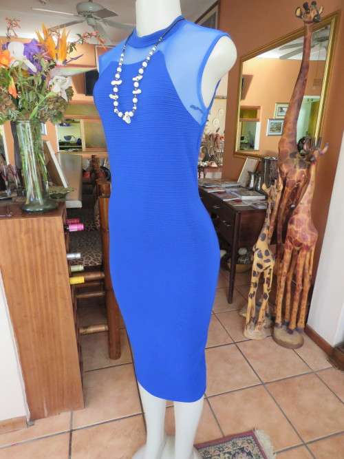 Bodycon dress in heavy stretch polyester fabric with high neckline.Size 32/8.Good condition.