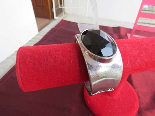 Fashion hinged bracelet.Chrome with large oval stone on top.Attractive accessory!!!Good condition.