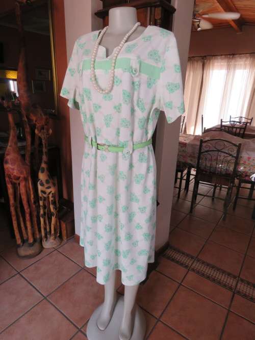 Cream dress with green floral pattern.Mint green inlay on front.Size 46/22.Good condition.