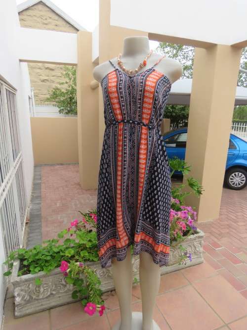 Cool summer beach dress in size 34/10 with thin adjustable shoulders straps.Used but in good cond.