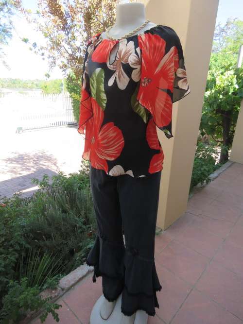 Chic black 100% polyester top with bold red flowers and green leafs.Size 34/10.As new.