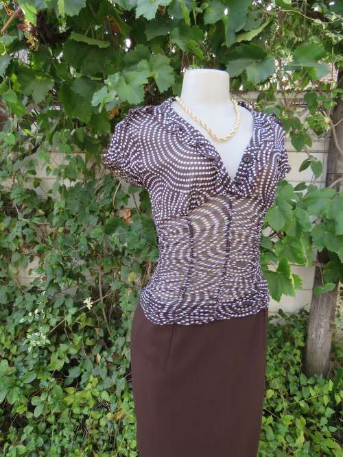 Sexy little sheer polyester/rayon top in brown/white polkadot design.By 'INWEAR'.Size 33/9.New cond.