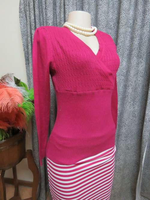Fabulous long sleeve magenta pink knitted top in size 34/10.Empire waist.Good condition.