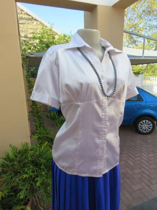 Shiny,silky white short sleeve top with empire waist.Size 36/12 by `NEW FEELING`.Good cond.